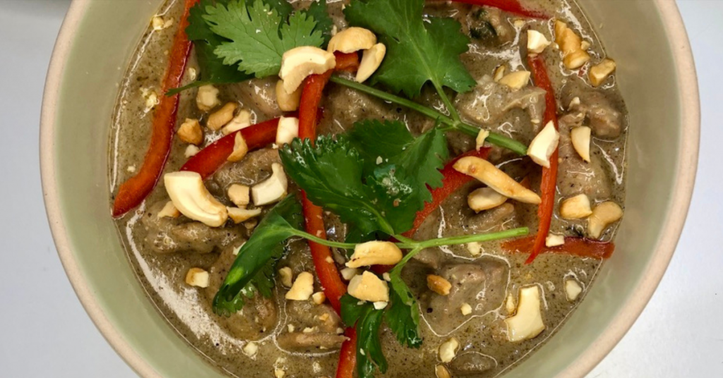 Recipes 6 a bowlof dark green curr topped with cashews, red pepper slices and cilantro
